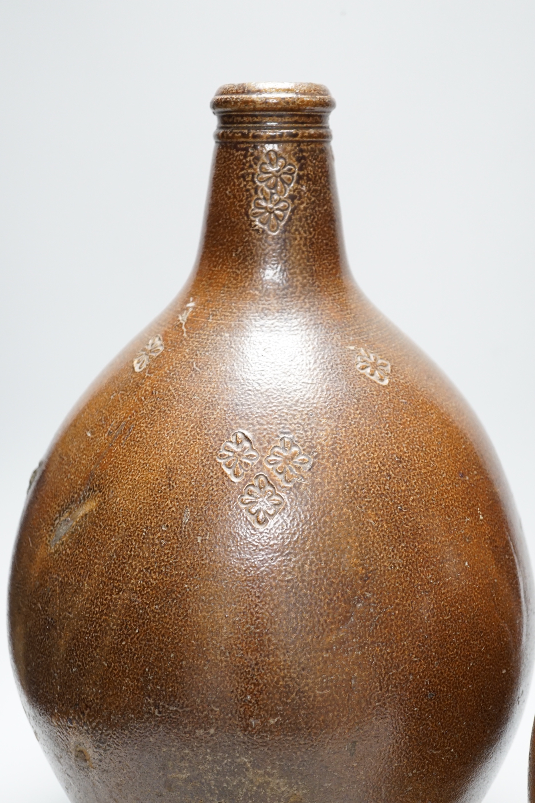 A large 17th century stoneware Bellarmine, incised Z, 42cm high and a large 18th century stoneware jug, 34cm high